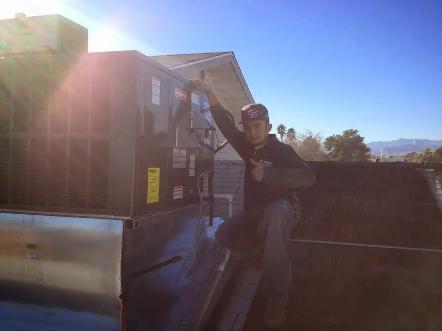 HVAC technician performing HVAC Inspection on a rooftop unit in Westphalia